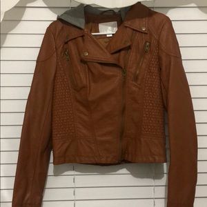 Woman faux leather jacket with hoodie